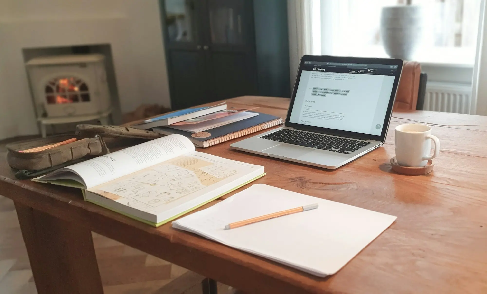 Laptop and notebook on a wooden desk